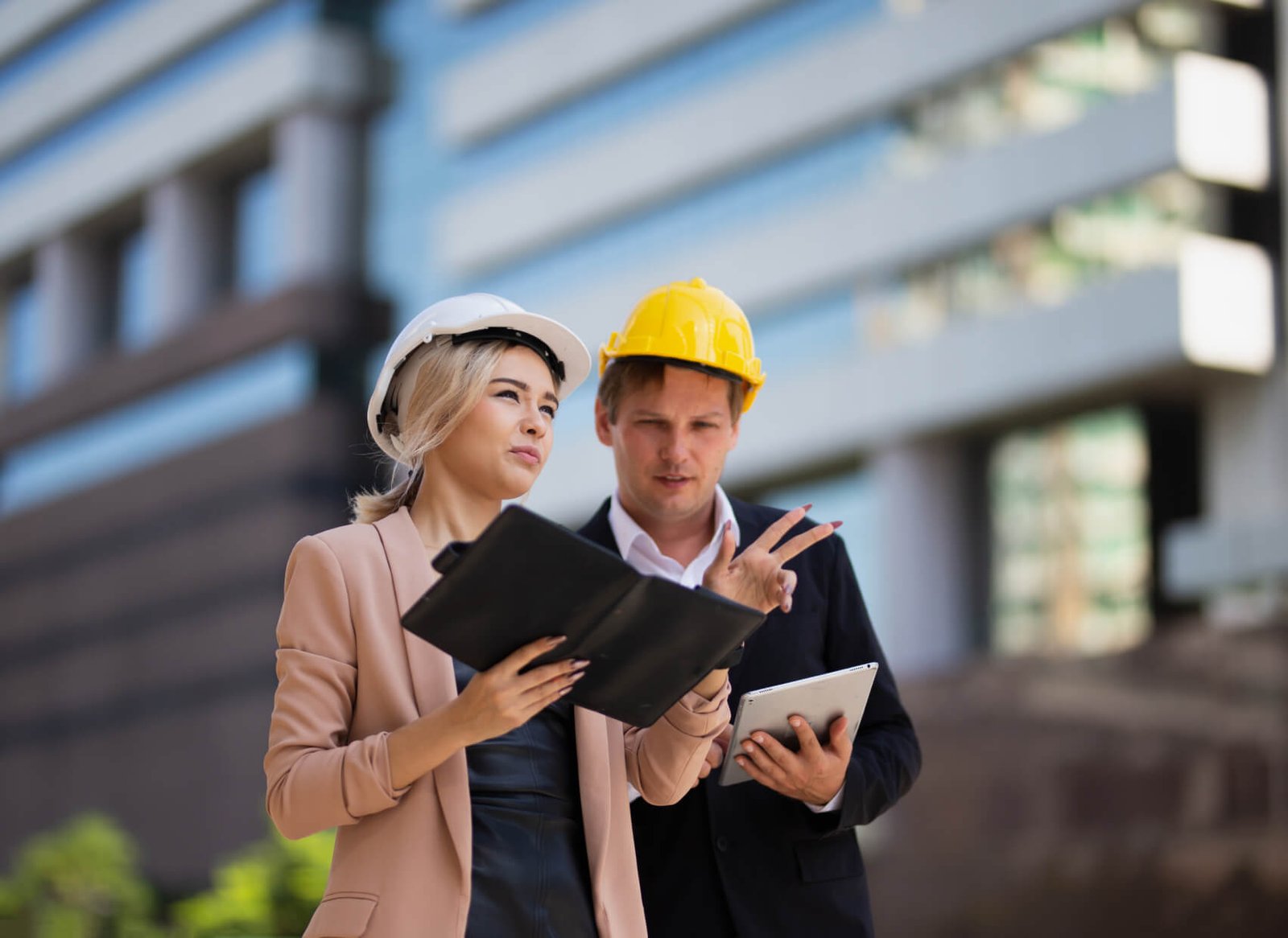 Skyward Highrise project managers reviewing plans on a construction site